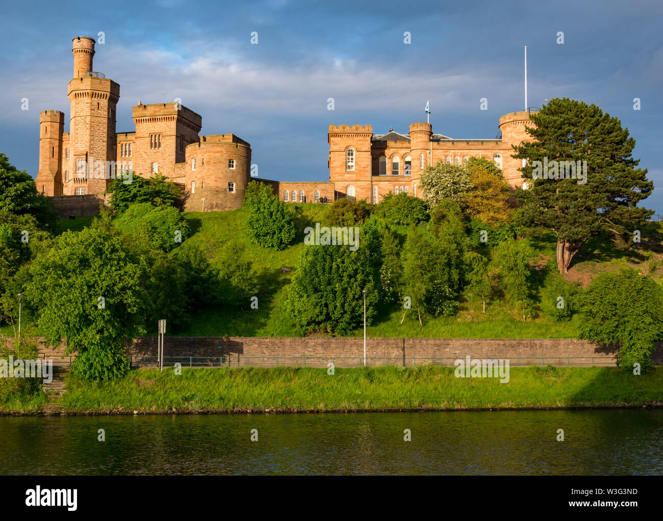 View across River Ness to sunlit  Inverness Castle on hilltop, Inverness, Scotland, UK Stock Photo