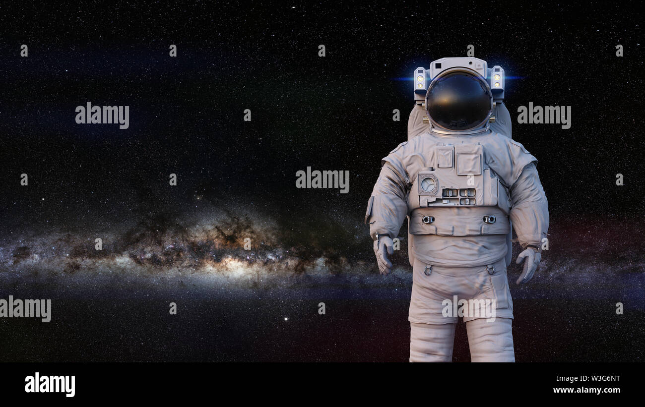 astronaut standing in front of the Milky Way galaxy Stock Photo