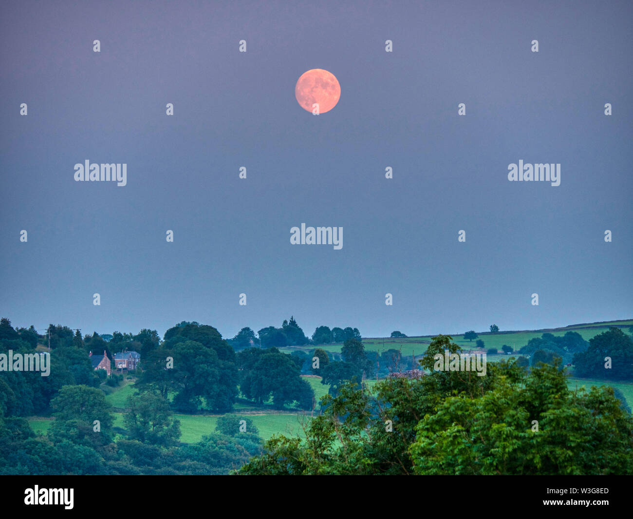 UK Weather: spectacular orange full Buck moon over  Wirksworth Derbyshire UK Stock Photo