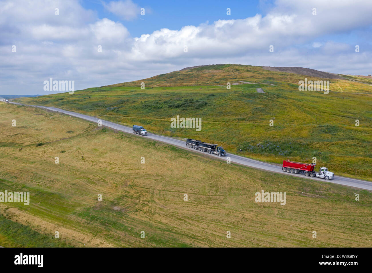 Northville Township, Michigan - Empty trucks descend from the Advanced Disposal landfill after dumping their loads of trash and garbage. Stock Photo