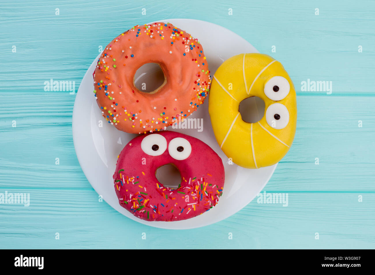Three different donuts on plate. Stock Photo