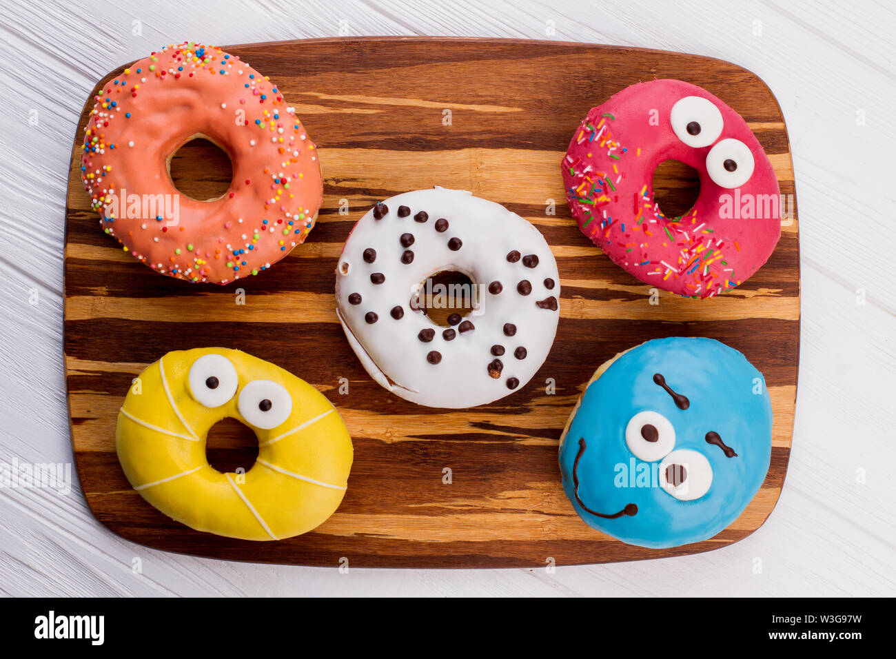 Assorted donuts on cutting board. Stock Photo