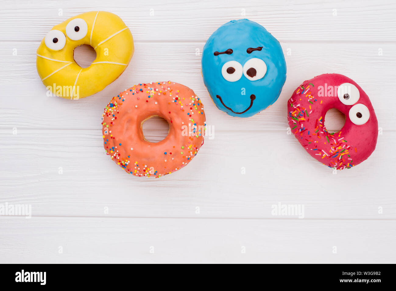 Glazed donuts on wooden background. Stock Photo