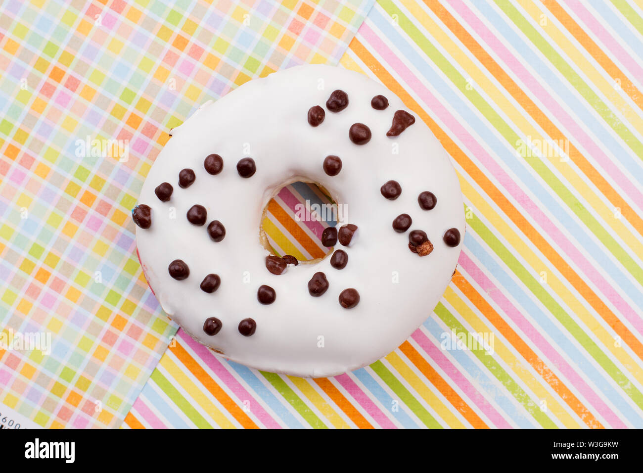 Donut on colored paper background Stock Photo - Alamy