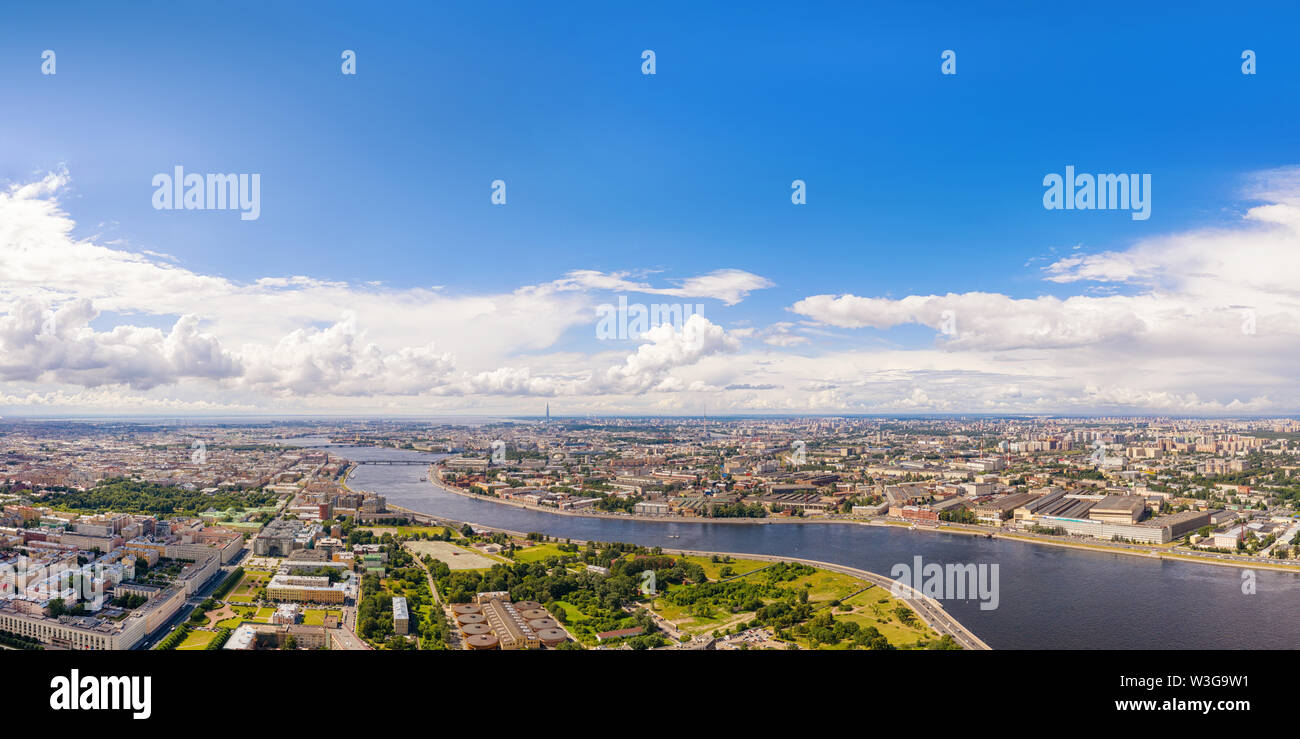 Aerial panoramic view of Neva river in Saimt Petersburg, Russia. Large wide angle cityscape with dramatic cloudy sky, copy space on the sky Stock Photo