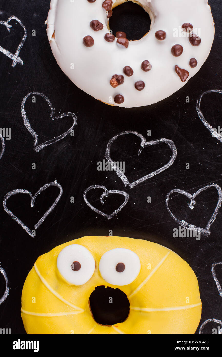 Hearts drawn with chalk and colorful donuts Stock Photo - Alamy