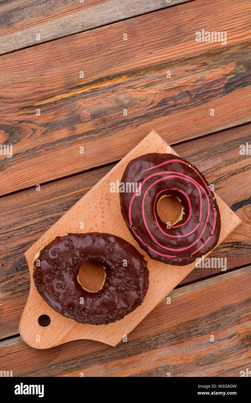 Donuts on wooden background, top view. Stock Photo