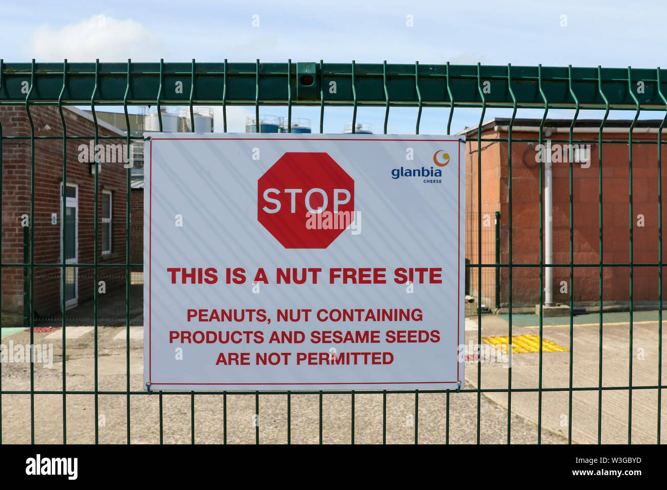 Food allergens listed on a warning sign on exterior fence of a nut free site or environment in the food industry at a Glanbia Cheese plant. Stock Photo