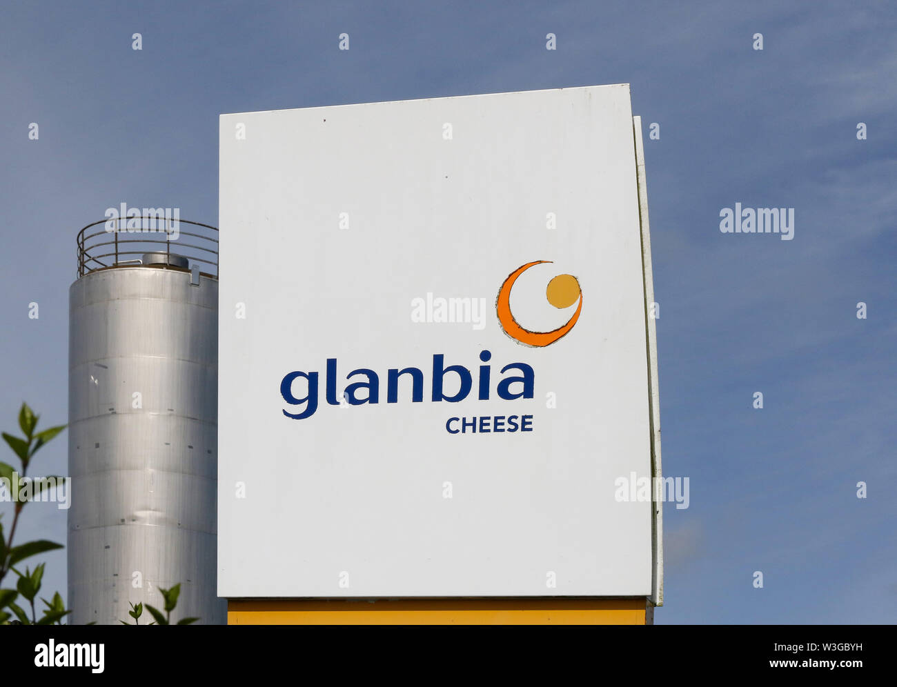 Glanbia logo and Glanbia Cheese sign beside milk processing silo and