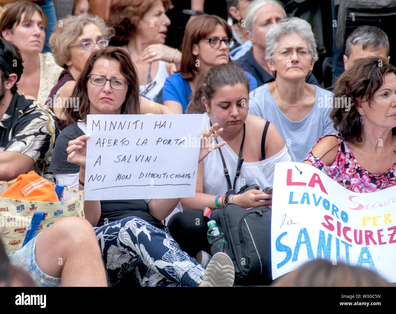 Rome, Italy. 15th July, 2019. Sit-in in front of the Chamber of Deputies (Montecitorio) against the Security Bis Decree organized by the Network Restiamo Umani. This morning a disproportionate number of police forces evacuated a former occupied school in the Primavalle district where about 300 people lived, including many children and former occupants, and the realities that had opposed the eviction this morning returned to Montecitorio in the afternoon. The parliamentarians Nicola Fratoianni and Riccardo Magi are also in the streets. Credit: Patrizia Cortellessa/Pacific Press/Alamy Live News Stock Photo