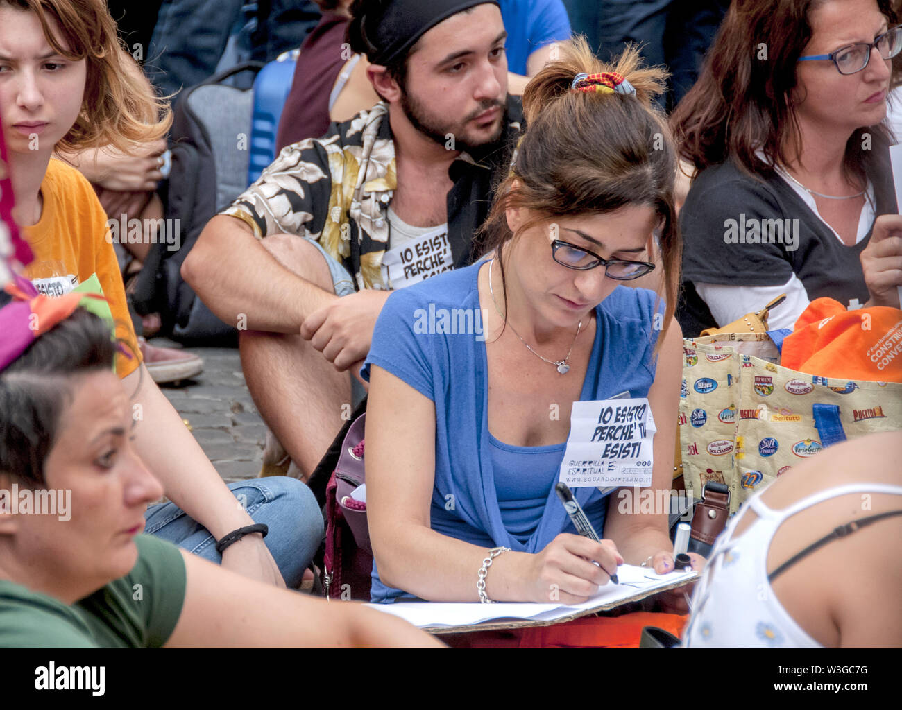 Rome, Italy. 15th July, 2019. Sit-in in front of the Chamber of Deputies (Montecitorio) against the Security Bis Decree organized by the Network Restiamo Umani. This morning a disproportionate number of police forces evacuated a former occupied school in the Primavalle district where about 300 people lived, including many children and former occupants, and the realities that had opposed the eviction this morning returned to Montecitorio in the afternoon. The parliamentarians Nicola Fratoianni and Riccardo Magi are also in the streets. Credit: Patrizia Cortellessa/Pacific Press/Alamy Live News Stock Photo