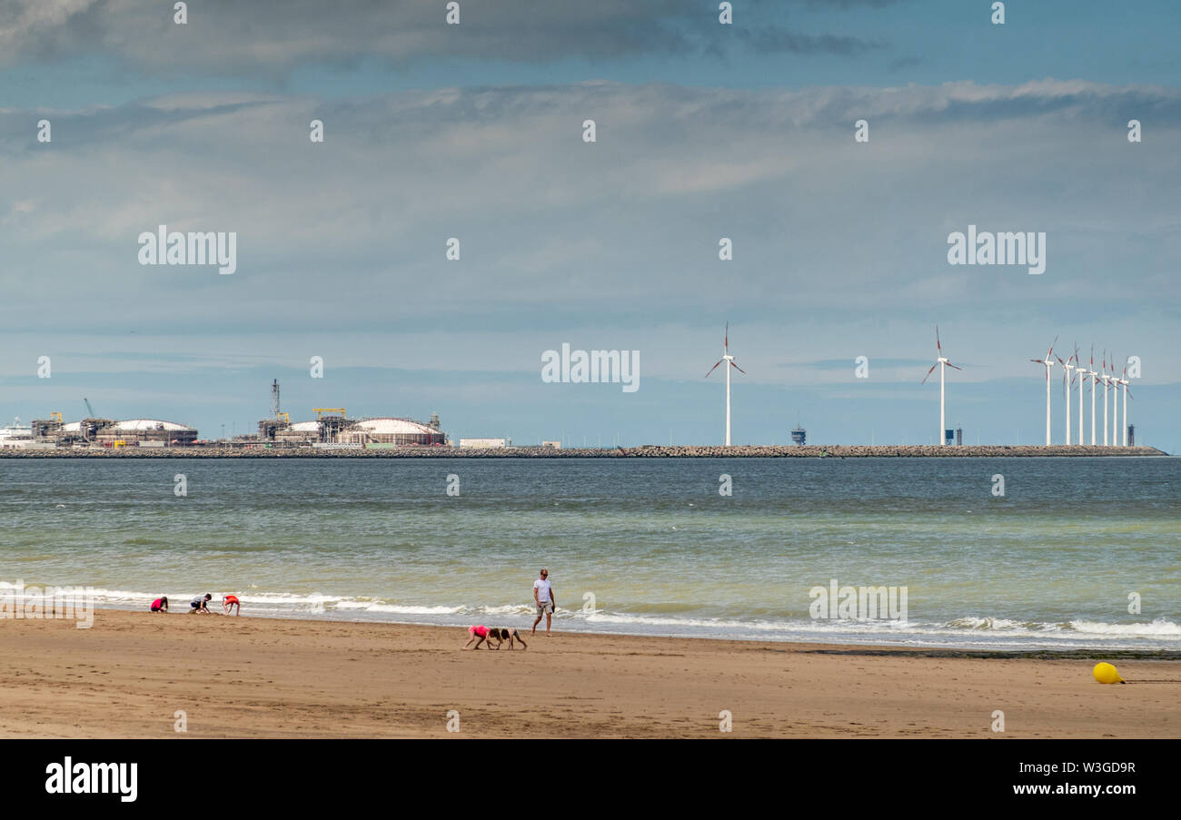Knokke-Heist, Flanders, Belgium -  June 16, 2019: Knokke-Zoute part of town. View from sandy beach on LNG sea terminal and Wind turbines of Port of Ze Stock Photo
