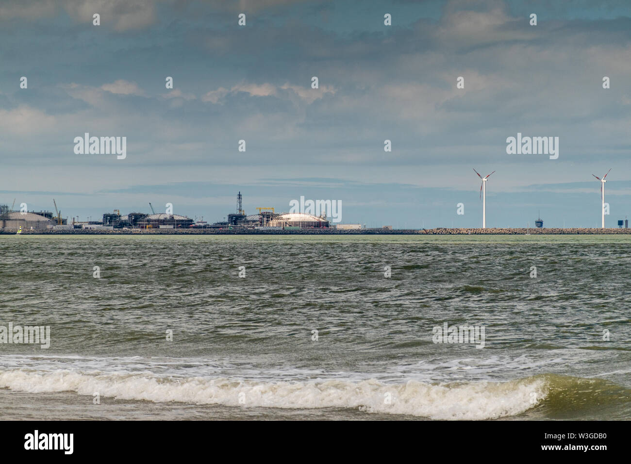 Knokke-Heist, Flanders, Belgium -  June 16, 2019: Knokke-Zoute part of town. View from sea edge on LNG sea terminal and Wind turbines of Port of Zeebr Stock Photo