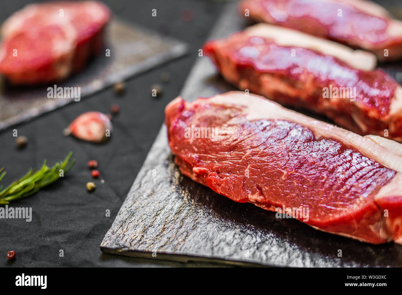 New york strip porterhouse steak beef meat against black background
