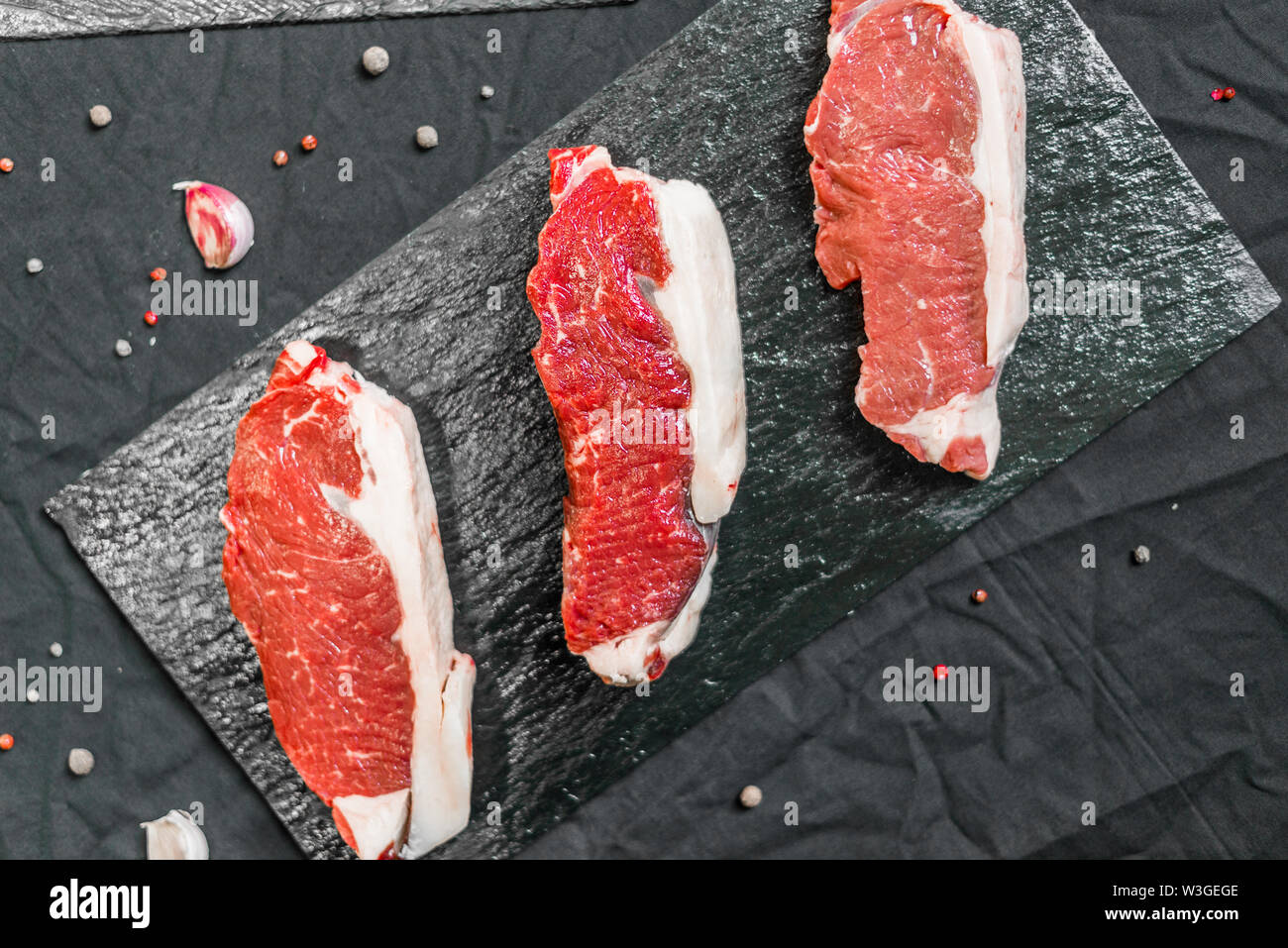 New york strip porterhouse steak beef meat against black background