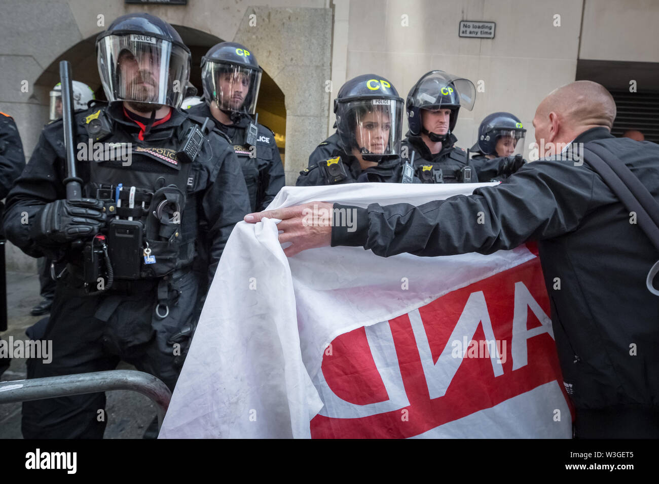 London, UK. 11th July 2019. Angry scenes of civil unrest outside Old Bailey court between riot police and supporters of Tommy Robinson. Sentenced under his real name of Stephen Yaxley-Lennon, a custodial sentence of 19 weeks is ordered after Tommy Robinson was found guilty of contempt of court over the filming outside Leeds Crown Court during a criminal trial last year and broadcasting live on social media. Credit: Guy Corbishley/Alamy Live News Stock Photo