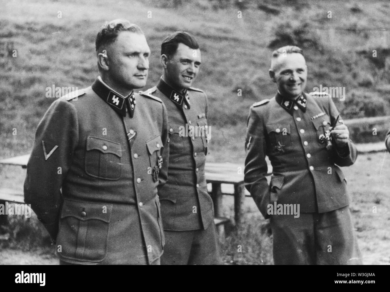 Auschwitz, Poland, Three SS officers socialize on the grounds of the SS retreat outside of Auschwitz, 1944. From left to right they are: Richard Baer (Commandant of Auschwitz), Dr. Josef Mengele and Rudolf Hoess (the former Auschwitz Commandant). Stock Photo