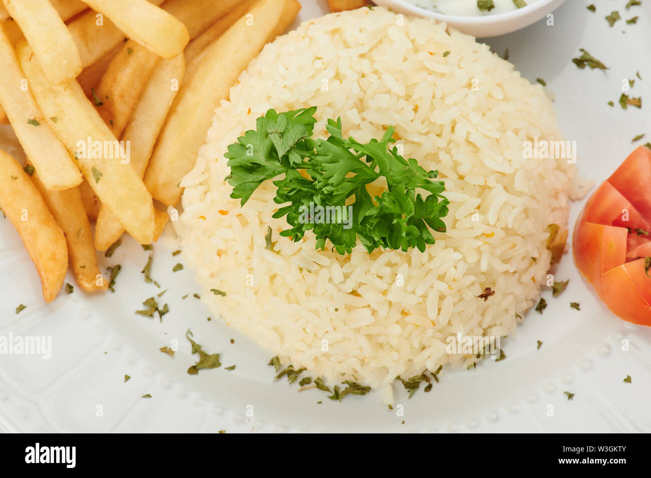 Pile of cooked rice with french fries close up view Stock Photo