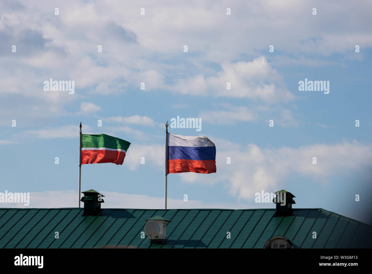 The flags of Russia and Tatarstan on a roof in Kazan, Russia Stock