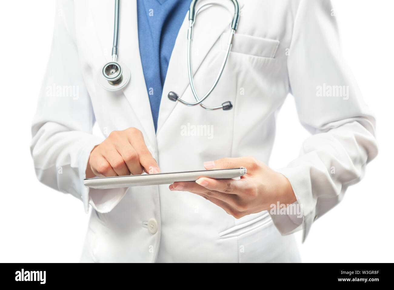 Woman doctor in white lab coat and stethoscope using tablet isolated