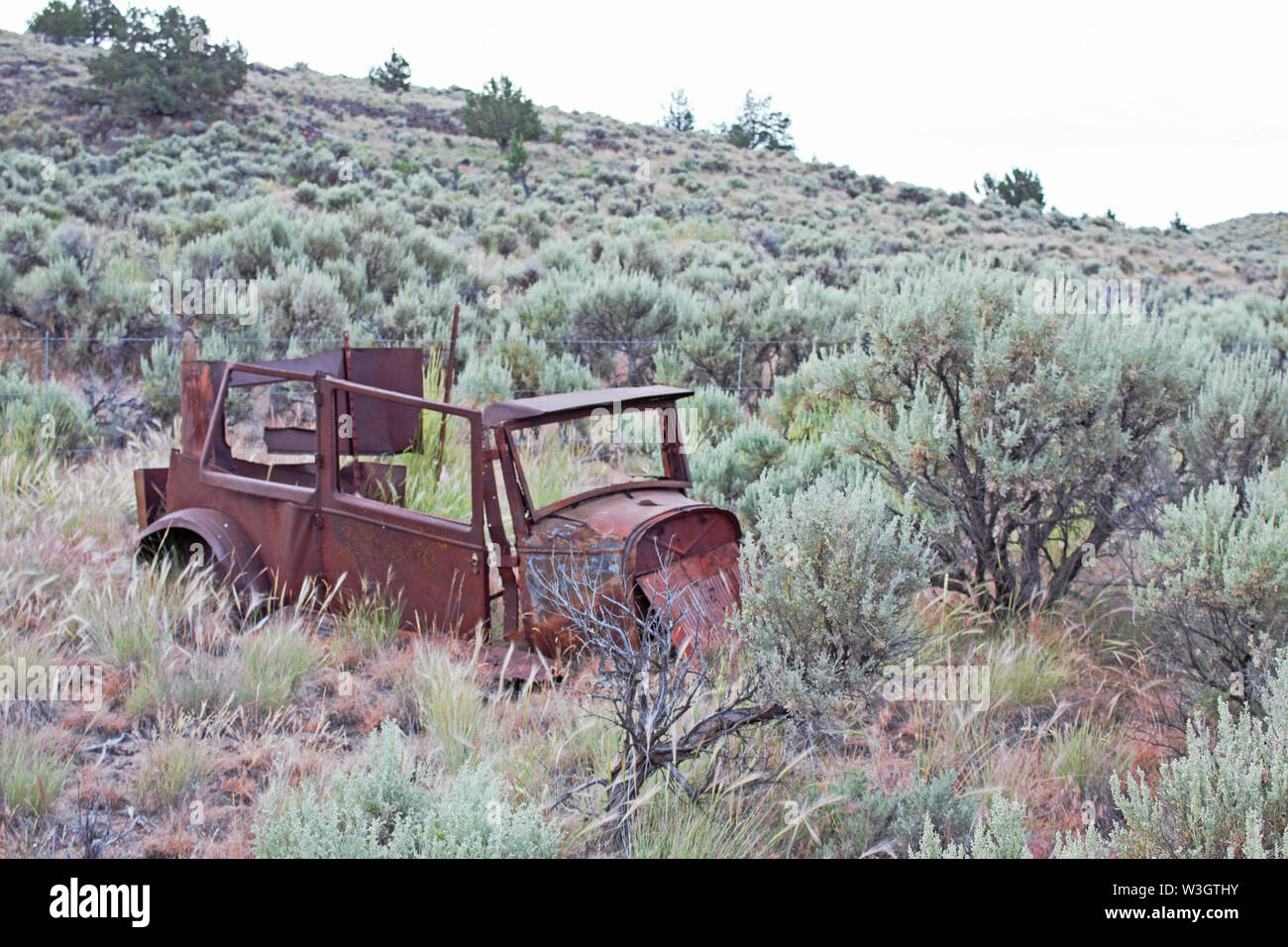 An antique car body decaying in the Oregon desert. Stock Photo