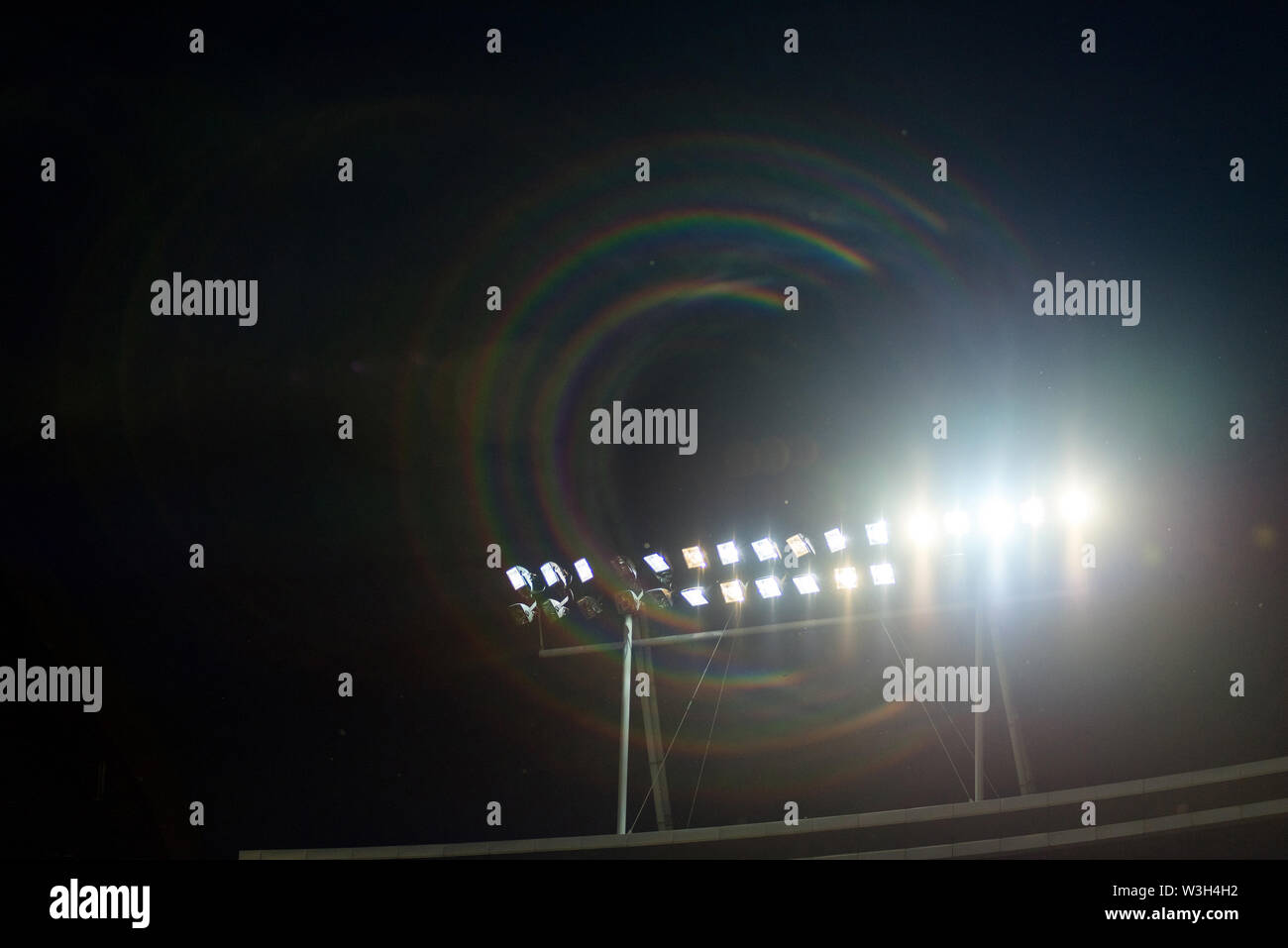 Stadium lights against blue sky during sunset Stock Photo
