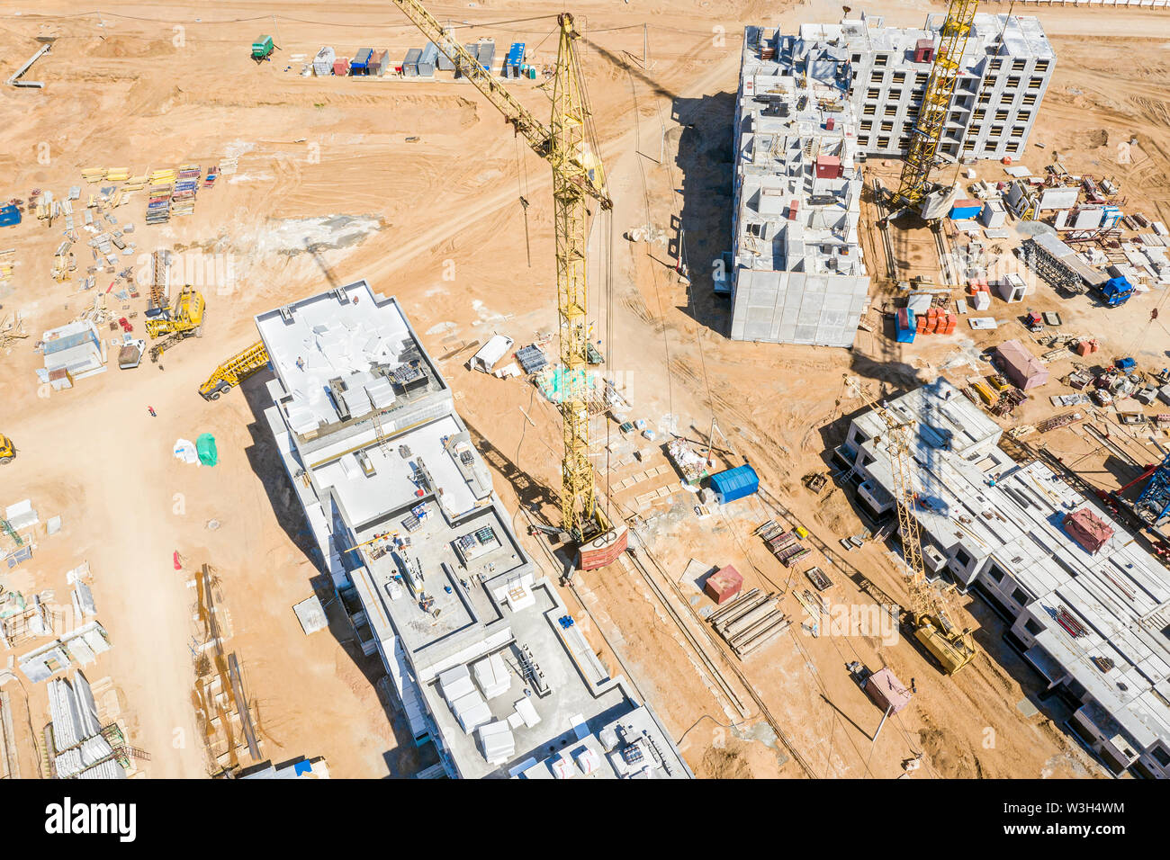 aerial image of city construction site with yellow tower cranes. drone ...