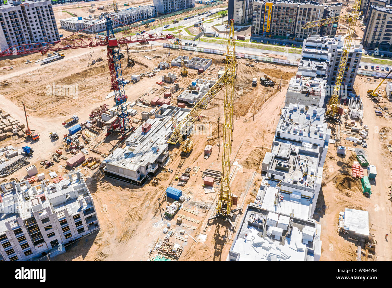 aerial panoramic view of city construction site with industrial tower cranes and other building heavy machinery Stock Photo