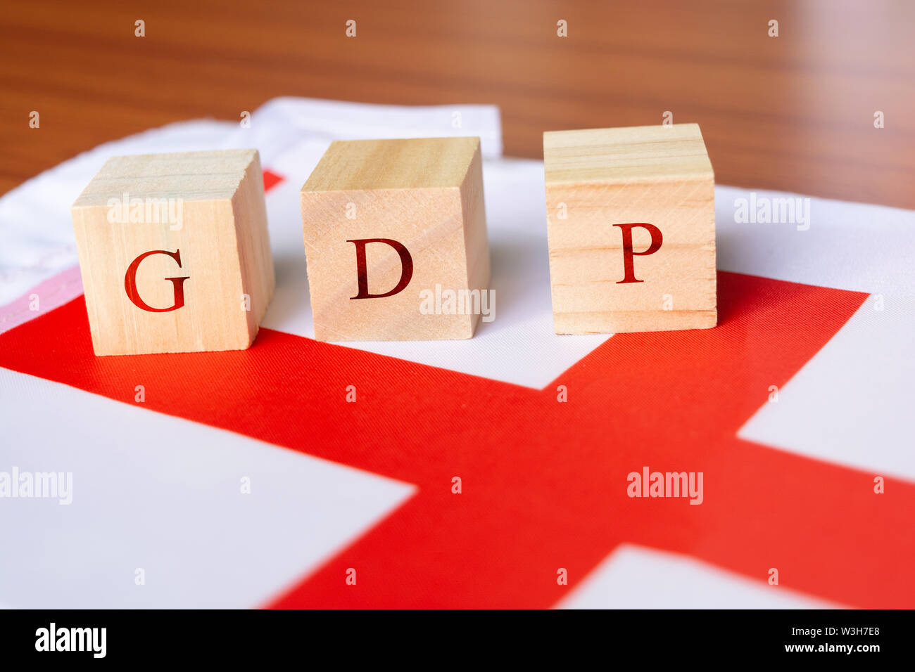 Concept of Gross Domestic Product or GDP of England, GDP in wooden block letter on England Flag Stock Photo