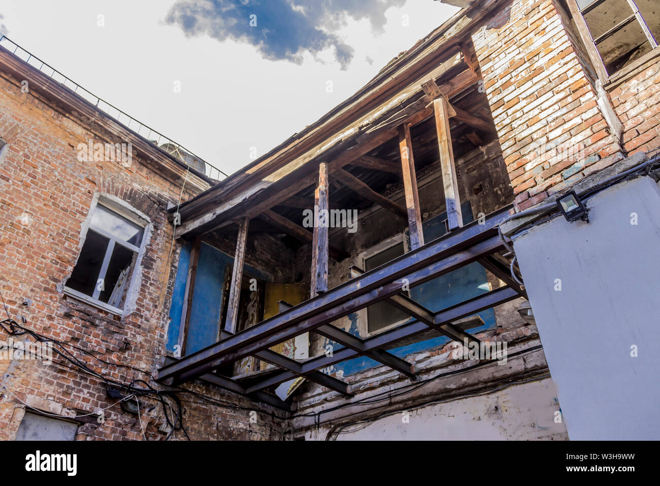 Transition between two old buildings .Construction of wood and metal profiles . Site about construction , architecture . Stock Photo