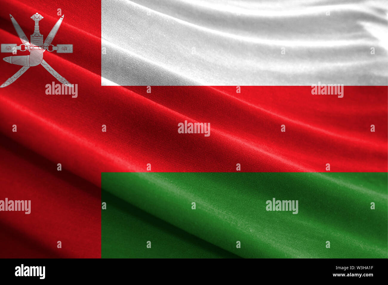Realistic flag of Oman on the wavy surface of fabric Stock Photo - Alamy