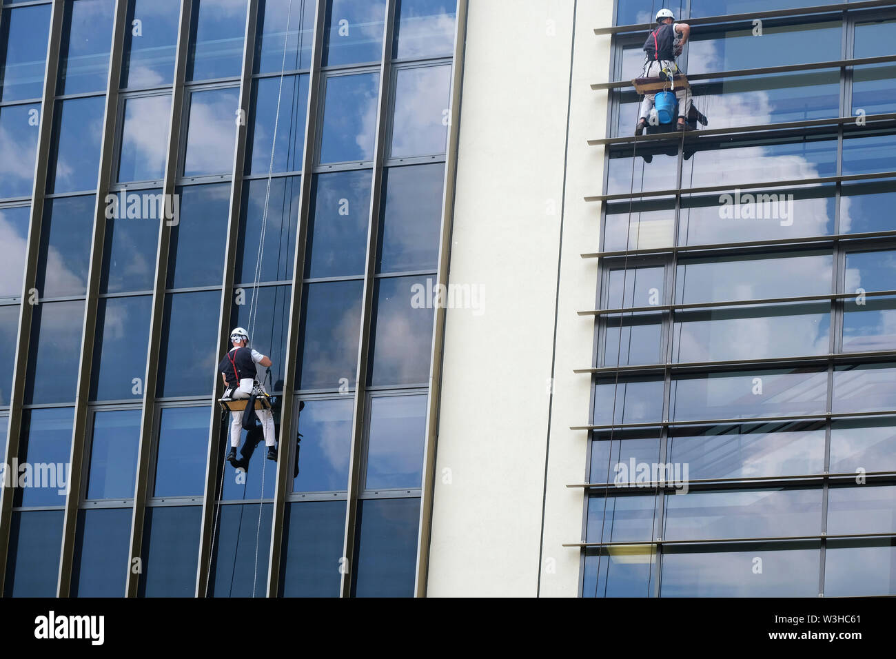 two men cleaning external glass wall of a modern building Stock Photo