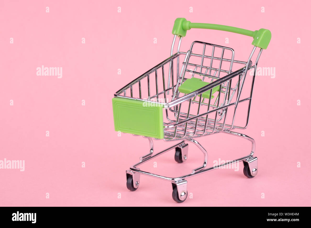 Empty shopping cart on a pink background Stock Photo