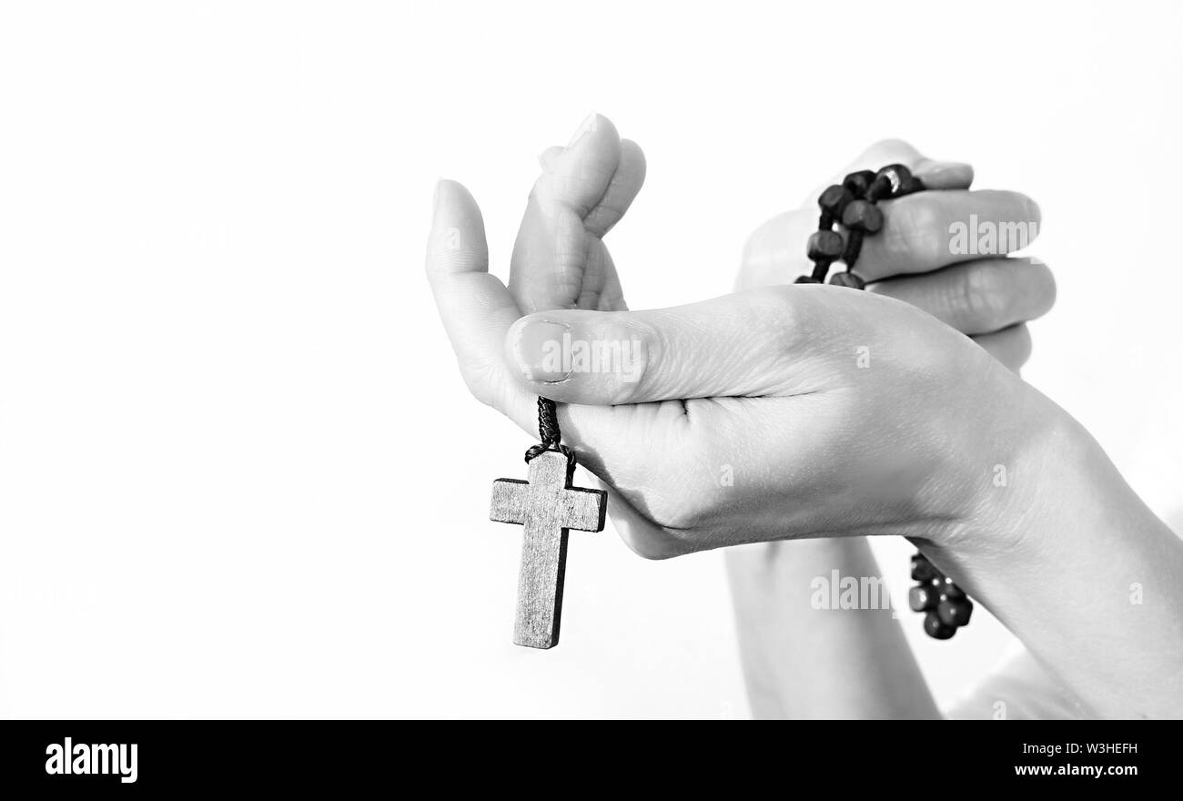 woman praying hand together reaching out with a crucifix and rosary beads cross stock image and stock photo Stock Photo