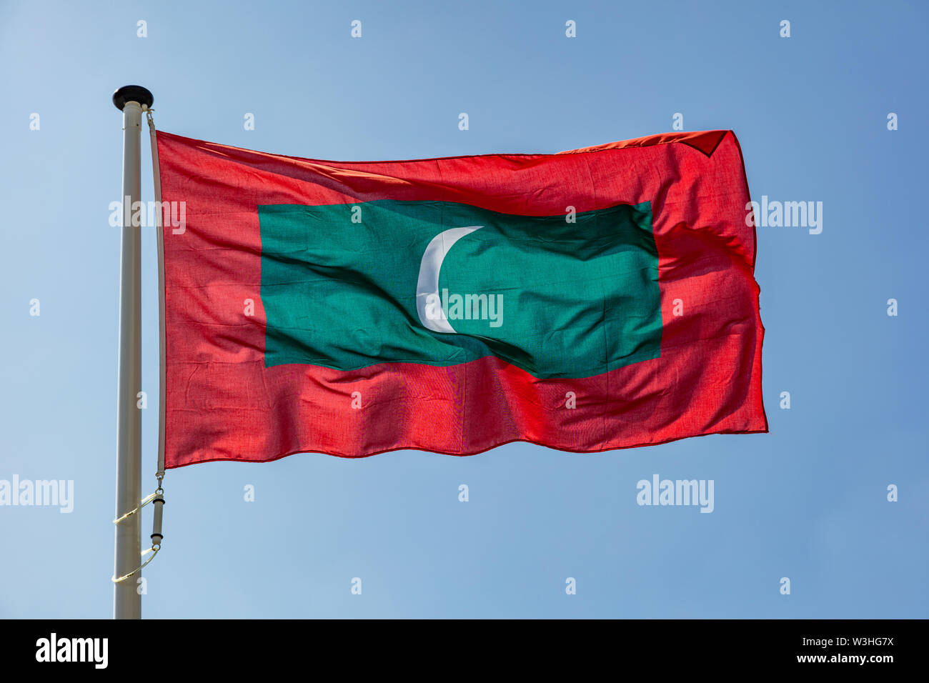 Maldives flag, Malawi national symbol waving against clear blue sky ...