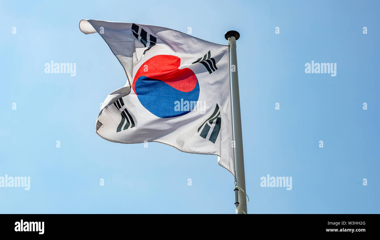 South Korea flag, National symbol waving against clear blue sky, sunny day Stock Photo