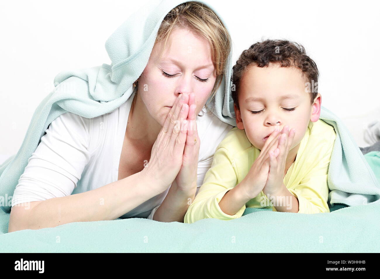 Kid praying with parent hi-res stock photography and images - Alamy