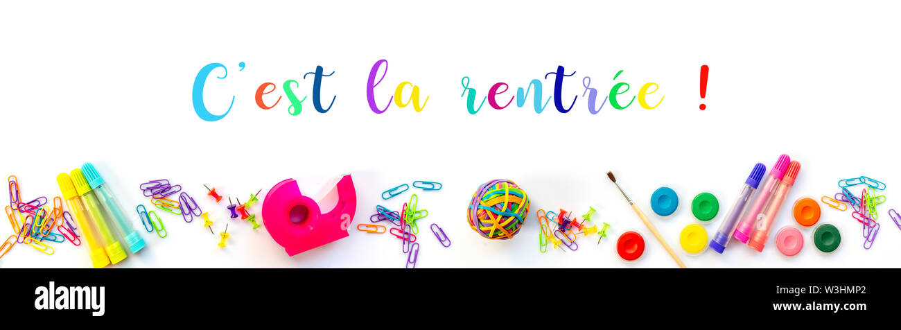 Panorama of colorful school supplies  on white background with with text 'c'est la rentree' meaning Back to School in French Stock Photo