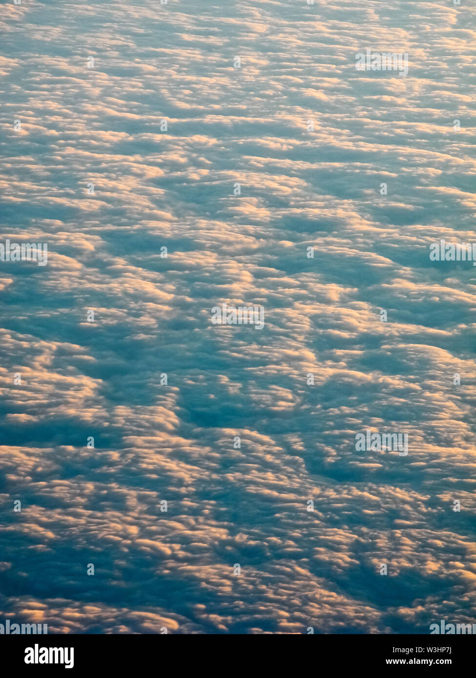 Aerial view from aircraft of sunset and clouds Stock Photo