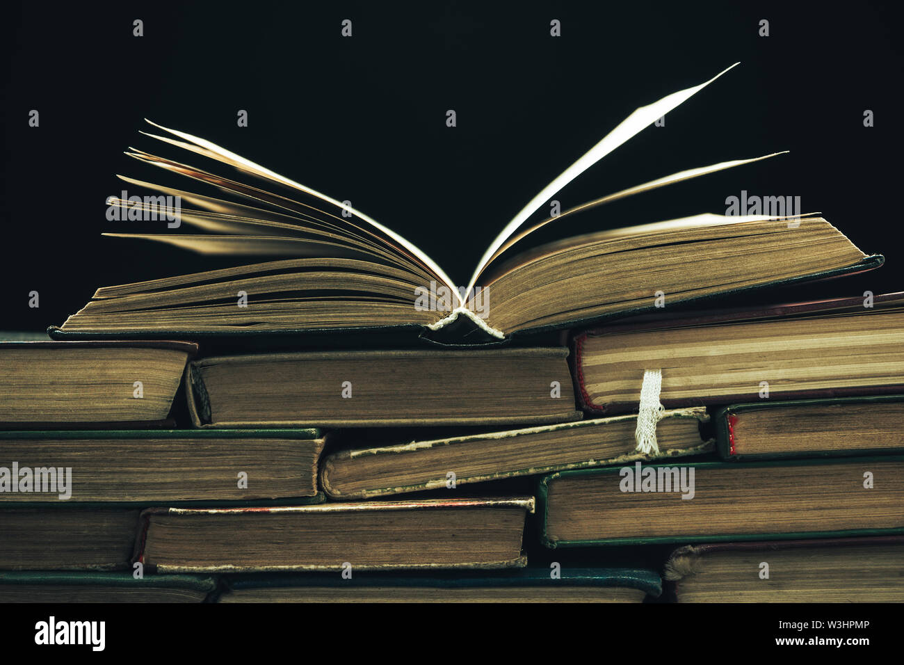 Close up Old books on a black background Stock Photo - Alamy