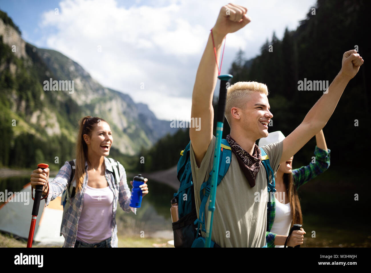 Group of friends hikers walking on a mountain at sunset Stock Photo - Alamy