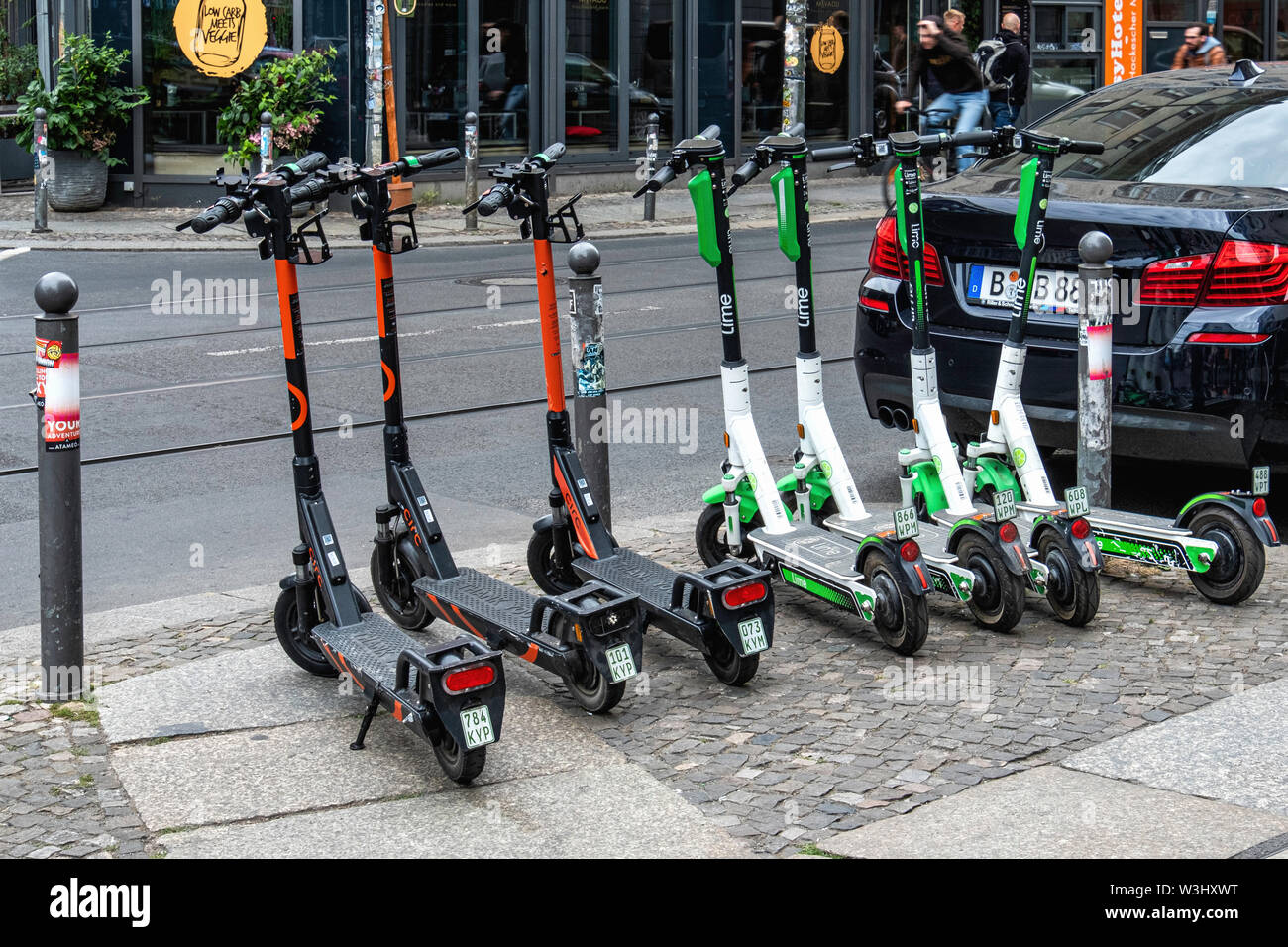 Circ & Lime e-scooters parked in a city street in Mitte-Berlin. The electric scooter is the latest form of transport in Germany.  E-scooters have recently been made legal for street use in Germany and are making an appearance in Berlin. Use is restricted to bike lanes & streets. The maximun speed allowed is 20kpm and under- fourteens are not permitted to use the scooters. Stock Photo