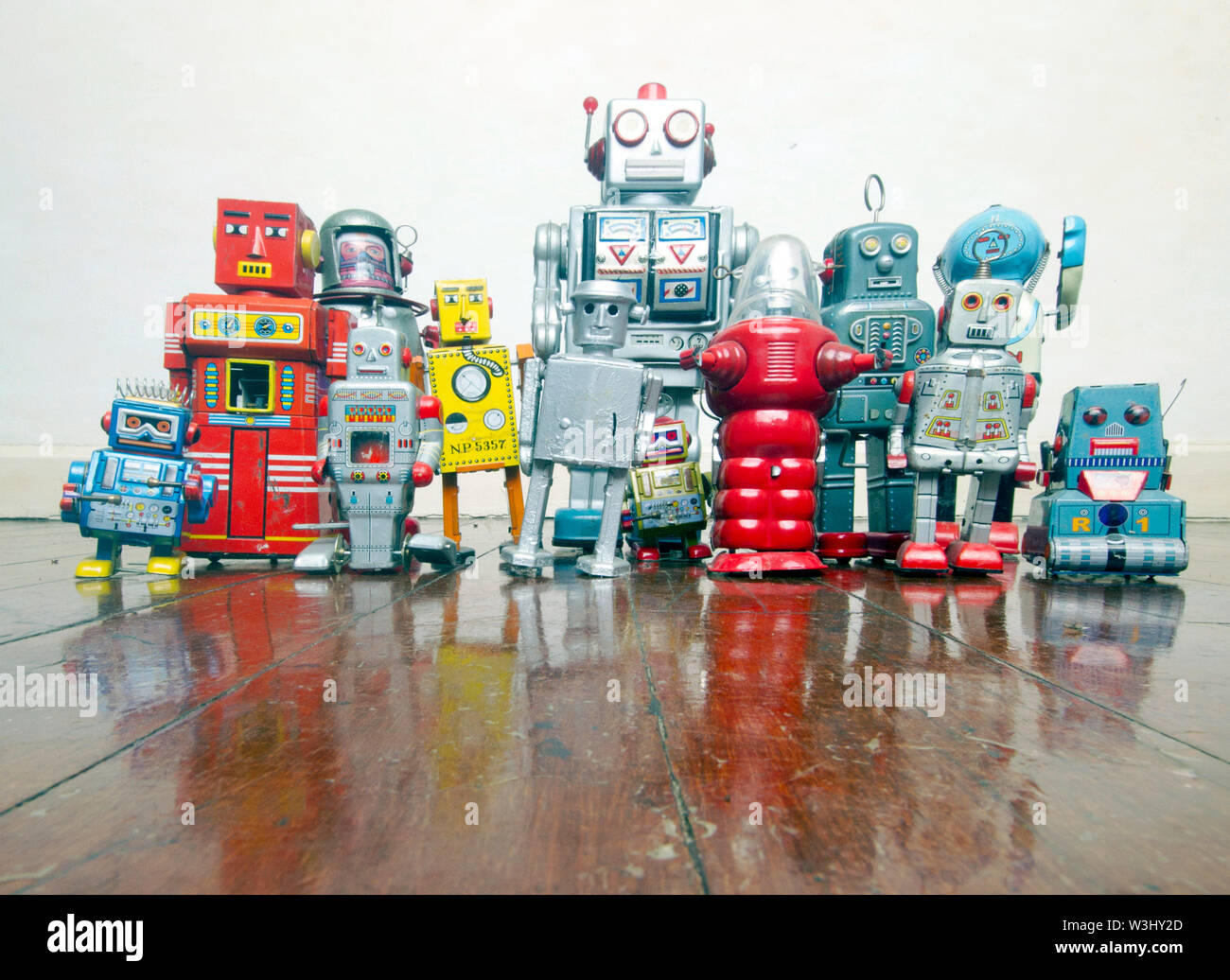 a big team of robots on an old wooden floor Stock Photo