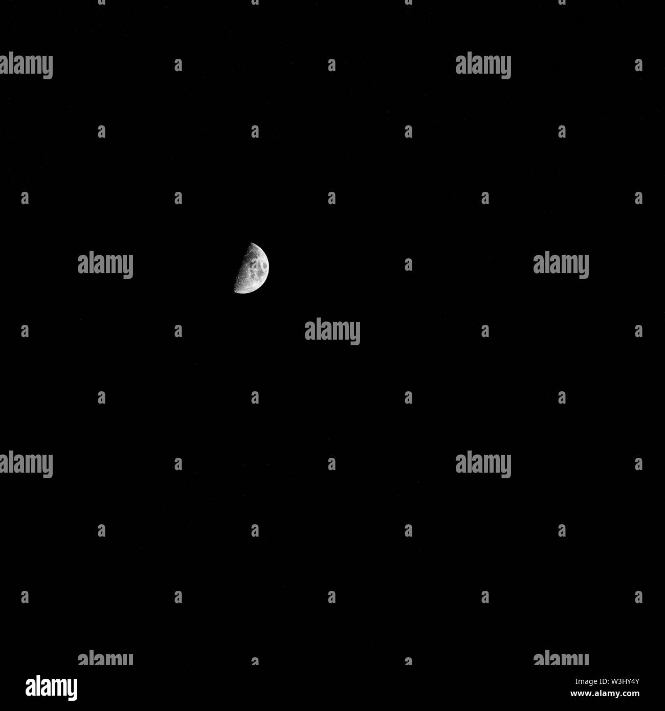 Half  phase moon in a dark sky Stock Photo