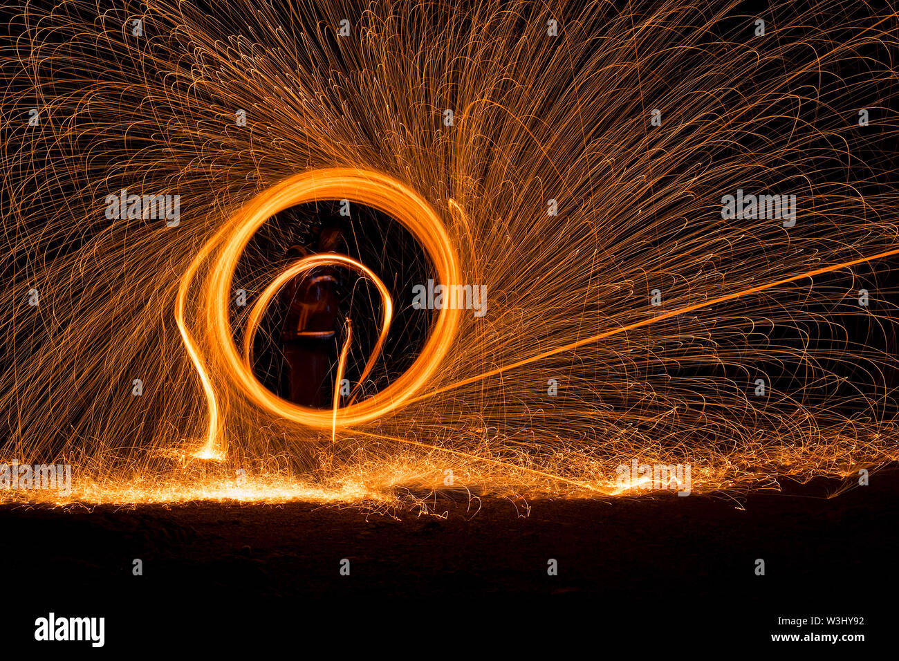 Steel wool photography with umbrella like a protection from burning steel Stock Photo