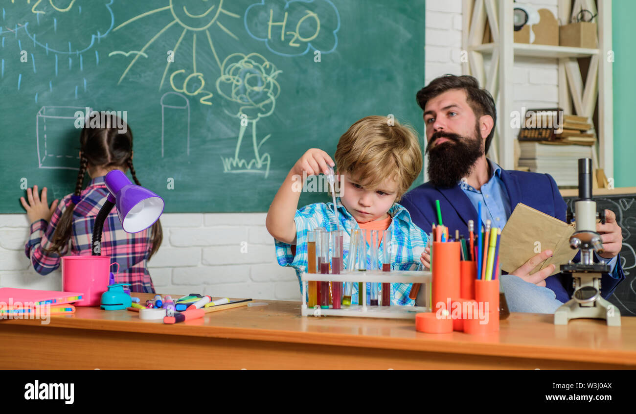 It is unbelievable. children making science experiments. Education. Science and education. chemistry lab. happy children teacher. back to school. doing experiments with liquids in chemistry lab. Stock Photo