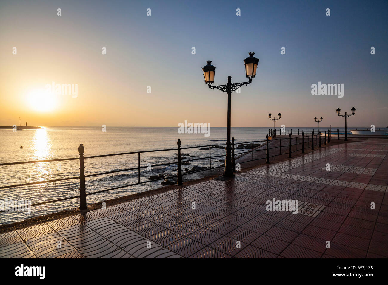 Santa Eularia des Riu, beach, bay and maritime promeande at dawn. Ibiza island, Balearic Islands, Spain. Stock Photo