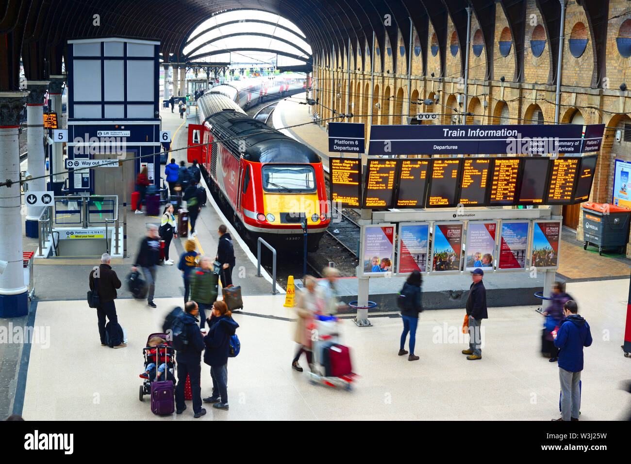 passengers boarding LNER class 43 (HST) train by digital train information boards at york station yorkshire united kingdom Stock Photo