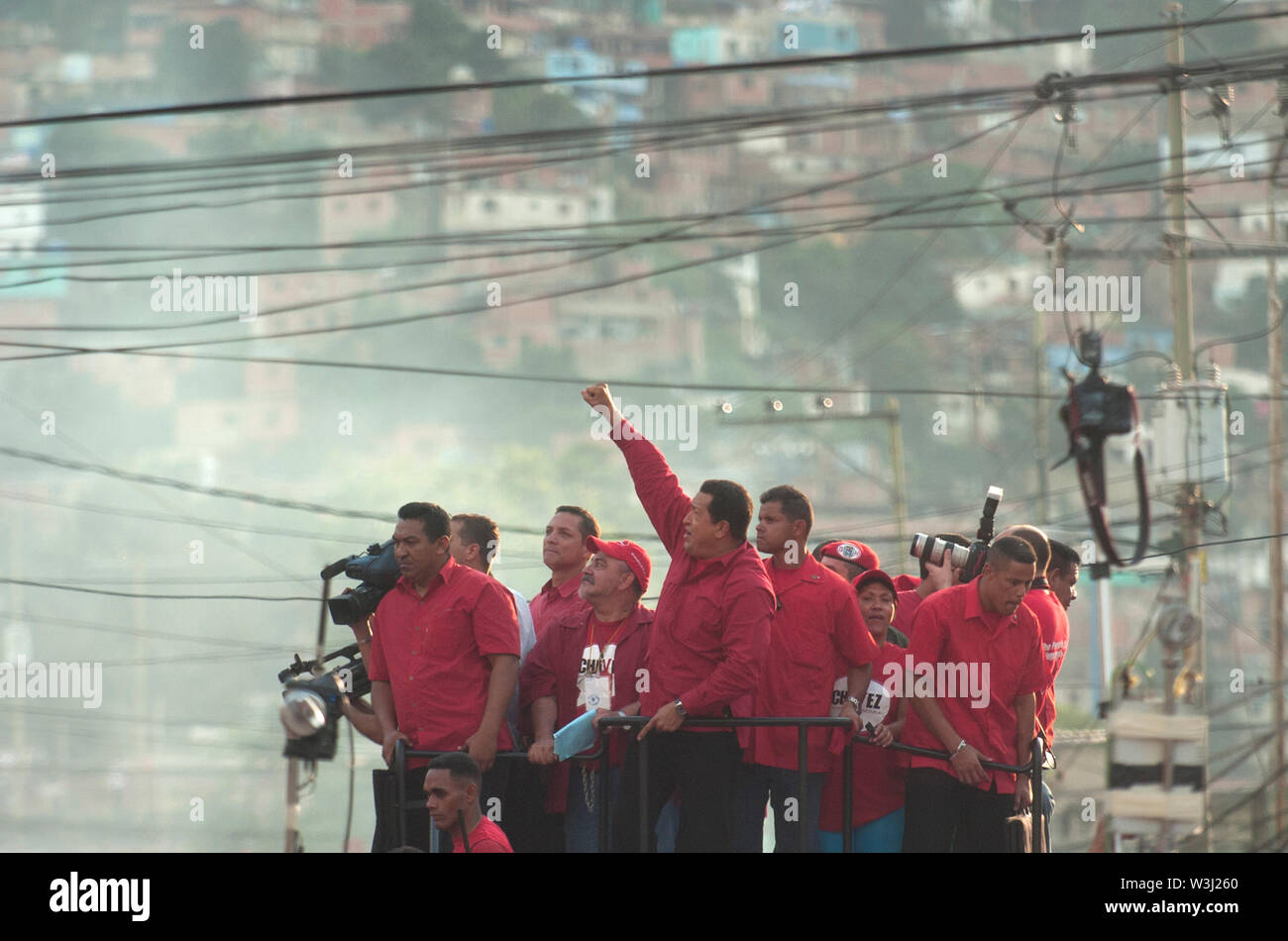 Venezuelan President Hugo Chavez, dressed in red, during an election campaign march in a poor neighborhood in Caracas, Venezuela Stock Photo