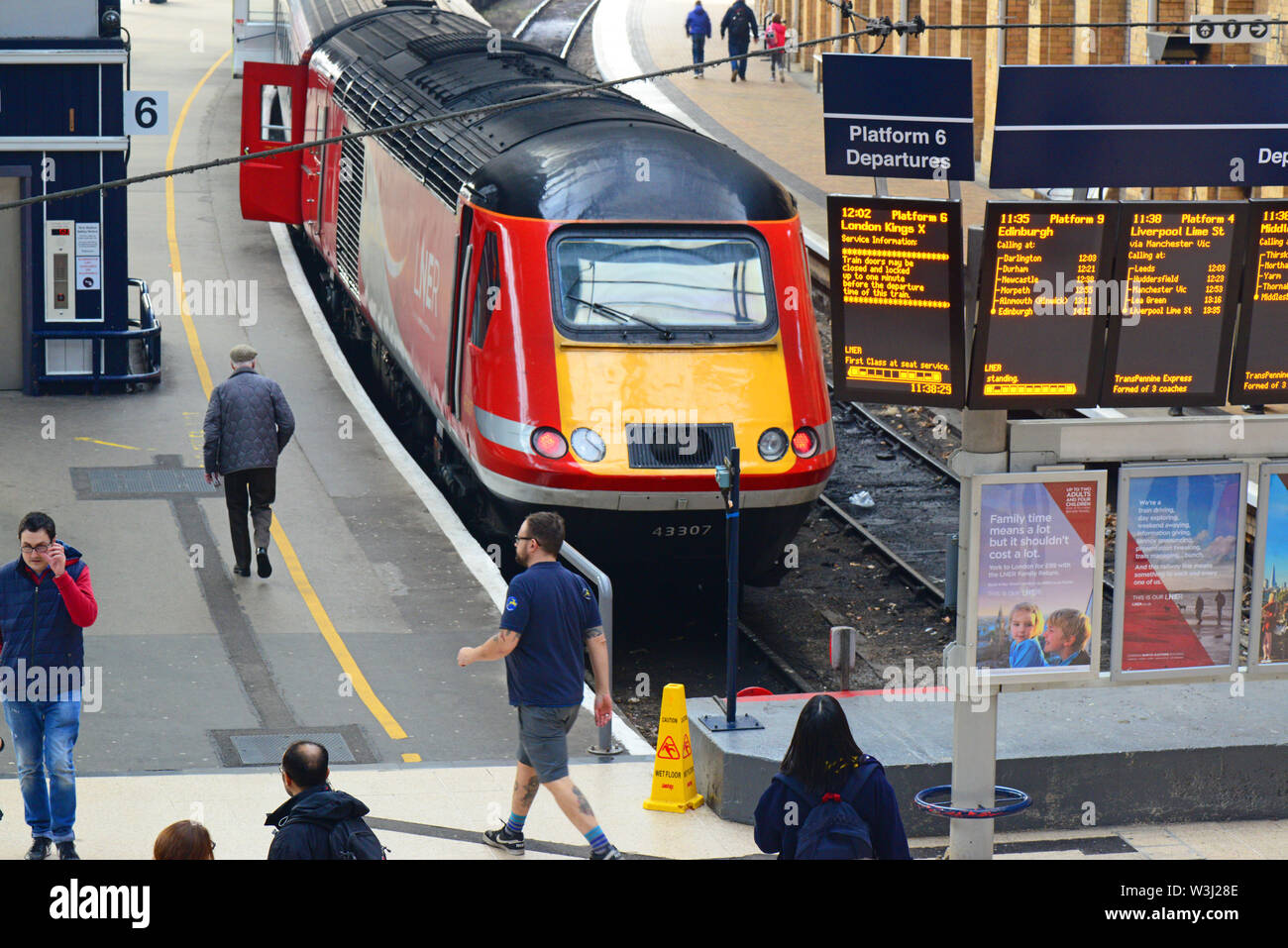 passengers boarding LNER class 43 (HST) train by digital train information boards at york station yorkshire united kingdom Stock Photo